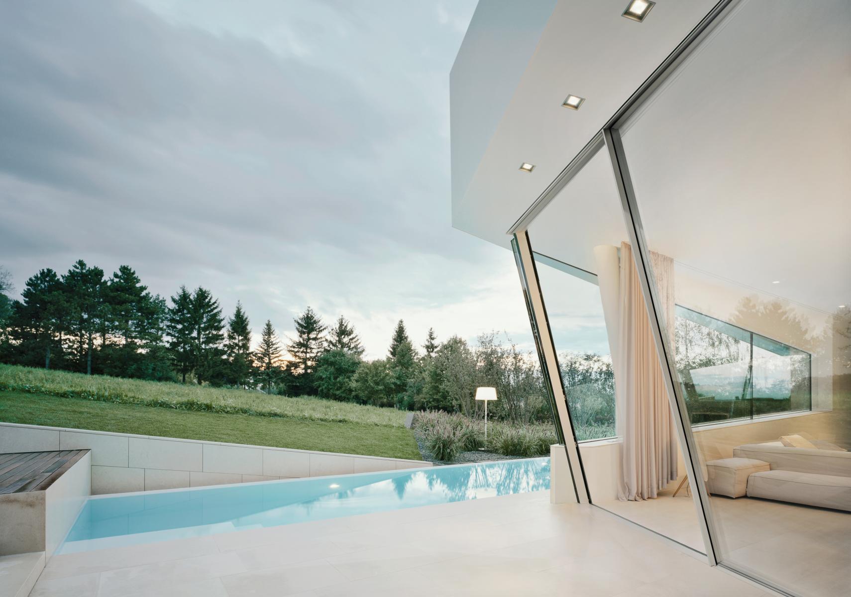 The Sky - Frame Slope system is the key to inclined sliding doors. The inclined glass units can either extend into the room or project outwards from the facade. The system meets all Sky - Frame standards while generating a distinctive spatial geometry. The bearing assembly is able to accommodate all vertical and horizontal forces, thereby ach ieving superior running performance.